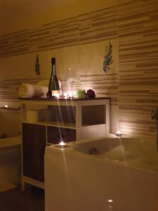 a bath tub with a bottle of wine and a glass at La Dolce Sosta - Tuscany in Chianciano Terme +33 photos