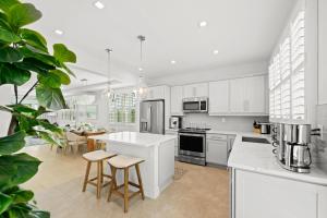 a kitchen with white cabinets and a table and chairs at Sea Salt at Hunter's Point in Cortez
