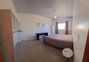 a bedroom with a bed and a staircase in a room at Apartamento em Imbituba -Village - Fabi in Imbituba +16 photos