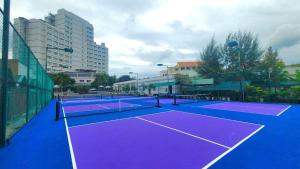 a couple of tennis courts with buildings in the background at TTC Hotel Phan Thiet in Phan Thiet