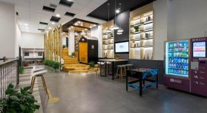 a store with a drink counter and stairs in it at Borrman Hotel Wuhan Yellow Crane Tower Fuxing Road Metro Station in Wuhan
