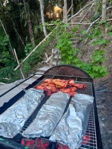 a grill with some meat on top of it at Baruk Mas Kampung Assum in Kuching +55 photos