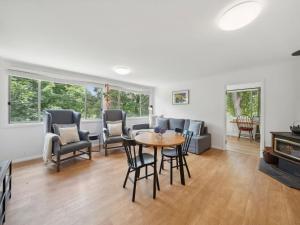 a living room with a table and chairs at Westlee Cottage in Wentworth Falls