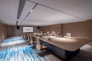 a large conference room with a long table and chairs at Home2 Suite by Hilton Harbin Central Street in Harbin