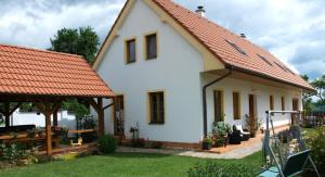 a white house with an orange roof at Apartments Odměny U Třeboně in Třeboň