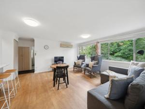 a living room with a couch and chairs and a table at Westlee Cottage in Wentworth Falls