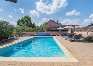 a swimming pool with blue water in a yard at Apple Mount Retreat in Lavenham