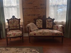 two chairs sitting in a room with windows at Tanglewood Inn in Greenville +19 photos