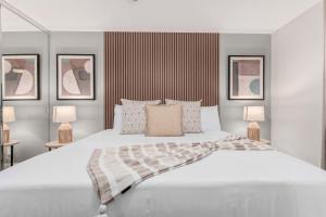 a bedroom with a large white bed with two lamps at NEW The Mesquite Retreat on Oak Entertainers Oasis in Scottsdale