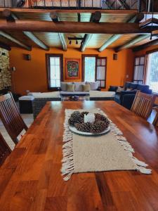 a living room with a large wooden table with chairs at El Charanguito Casa Quinta in Capilla del Señor