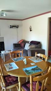 a table and chairs in a living room with a couch at Cheerful Bush House in Hepburn Springs