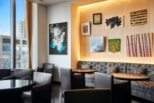 a restaurant with tables and chairs and a window at Park Hotel Tokyo in Tokyo