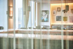 a lobby with a table and chairs in a building at Park Hotel Tokyo in Tokyo