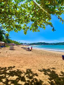 una spiaggia con sedie e ombrelloni e l'oceano di Casa na praia de Ubu - Anchieta a Anchieta