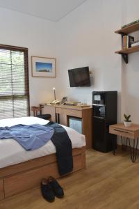 A bed or beds in a room at Rumanami Residence