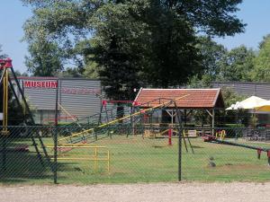 a park with a playground with a roller coaster at Hoeve Heidonk in Horn