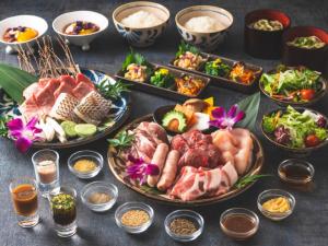 a table topped with plates of food and bowls of food at The Orion Hotel Motobu Resort & Spa in Motobu