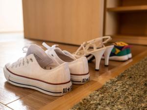 two pairs of shoes sitting on a floor at The Orion Hotel Motobu Resort & Spa in Motobu