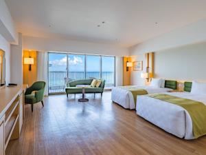 a hotel room with two beds and a balcony at The Orion Hotel Motobu Resort & Spa in Motobu