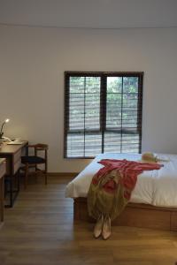 A bed or beds in a room at Rumanami Residence