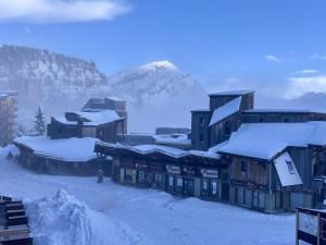 a town covered in snow with a mountain in the background at Appartement 4 pers, balcon sud-est, quartier Falaise - FR-1-634-109 in Morzine +6 photos