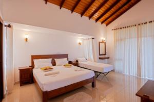 Postel nebo postele na pokoji v ubytování Abhayawewa Resort