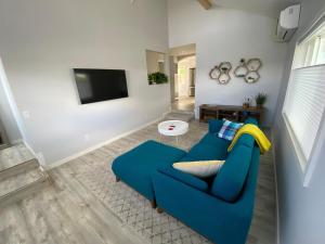 a living room with a blue couch and a tv at 4th Street in Bend