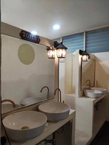 a bathroom with three sinks and two mirrors at Infinite Idol Home in Bangkok +22 photos