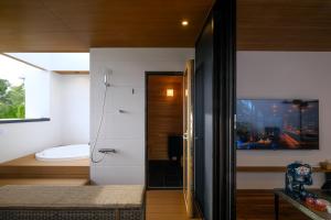 a room with a bathroom with a toilet and a window at MIRATIO Saphir in Onna