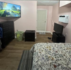 a bedroom with a bed and a flat screen tv at Retreats at Fort-Lauderdale in Margate
