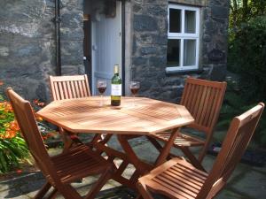 a wooden table with two glasses of wine on it at 1 Penygroes in Penmachno +20 photos