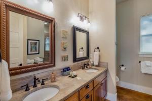 a bathroom with two sinks and a large mirror at Driftwood Casitas - Birdsong Casita in Wimberley +18 photos
