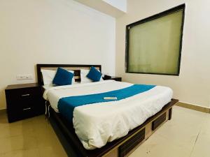 a bedroom with a large bed and a large screen at Silver Key Suites in Nagpur