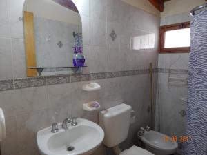 a bathroom with a sink and a toilet and a mirror at Alojartur in San Rafael +11 photos