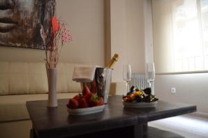 a table with fruit on it with wine glasses at Apartamento Santa Eulalia in Merida +19 photos