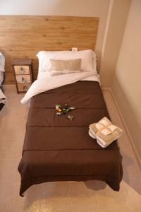 a bedroom with a large bed with some toys on it at Apartamento Santa Eulalia in Merida