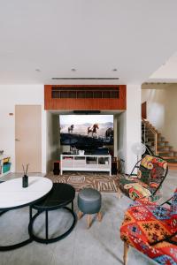 uma sala de estar com um sofá e uma televisão em Danny's Home em Zhongpu