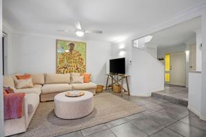 a living room with a couch and a table at Calinda Sol 11 in Byron Bay