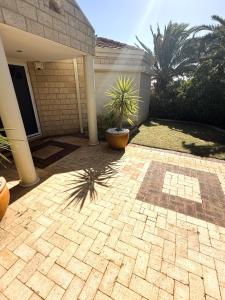 a patio of a house with a plant in a pot at 22 Home Sweet Home Coastal Currambine in Perth