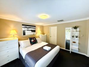 a bedroom with a large white bed in a room at 22 Home Sweet Home Coastal Currambine in Perth