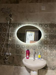 a bathroom with a sink and a mirror at Miracle Pyramids View Hotel in Giza