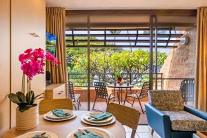 a living room with a table and chairs at Kuleana Club #510 - Ocean View -1 bedroom & 1 bathroom - 2nd Floor in Kahana