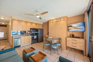 a kitchen and dining room with a table and chairs at Kuleana Club #510 - Ocean View -1 bedroom & 1 bathroom - 2nd Floor in Kahana