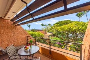 a balcony with a table and chairs and a view at Kuleana Club #510 - Ocean View -1 bedroom & 1 bathroom - 2nd Floor in Kahana