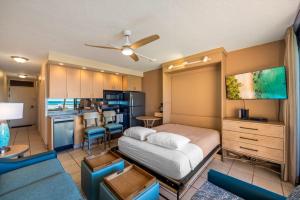 a bedroom with a large bed and a kitchen at Kuleana Club #510 - Ocean View -1 bedroom & 1 bathroom - 2nd Floor in Kahana