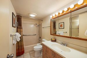a bathroom with a sink and a toilet and a mirror at Kuleana Club #510 - Ocean View -1 bedroom & 1 bathroom - 2nd Floor in Kahana