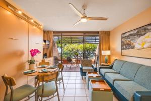 a living room with a couch and a table at Kuleana Club #510 - Ocean View -1 bedroom & 1 bathroom - 2nd Floor in Kahana