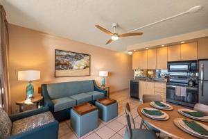 a living room with a couch and a table at Kuleana Club #510 - Ocean View -1 bedroom & 1 bathroom - 2nd Floor in Kahana