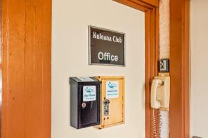an office sign on a wall next to a door at Kuleana Club #510 - Ocean View -1 bedroom & 1 bathroom - 2nd Floor in Kahana