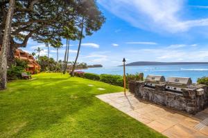 a lawn with a view of the ocean at Kuleana Club #510 - Ocean View -1 bedroom & 1 bathroom - 2nd Floor in Kahana